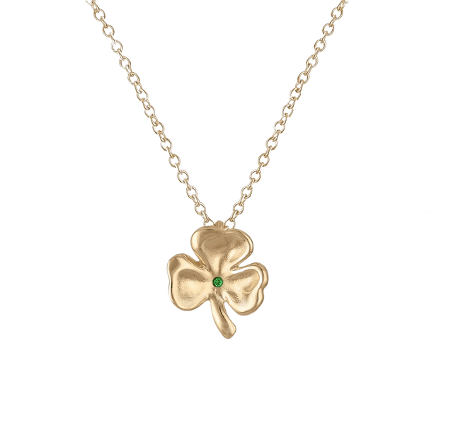 Close-up of a gold clover necklace highlighting the metal finish.